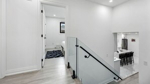 A modern interior with a staircase, a kitchen area, and a bedroom. - Luxury 3 BDRM Home In Toronto Ontario (Toronto)