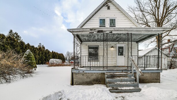 A white house with a porch and steps leading to the front door. - Near Hiking & Skiing: Cozy Home in Cortland! (Cortland)