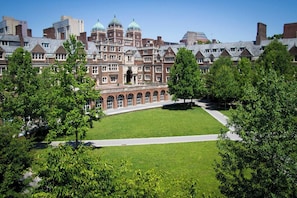 A large, historic building with a central courtyard surrounded by trees. - Stylish 3BR Apt w/Laundry Near UPenn&Drexel (Philadelphia)