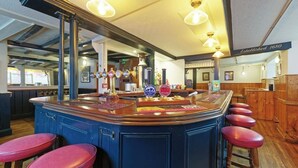 A bar area with a blue counter, multiple stools, and a beer tap. - The Northern Belle (Margate)