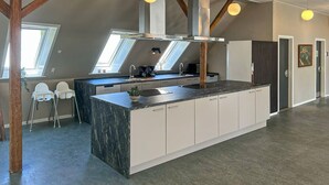 A modern kitchen with a large island, skylights, and a view of the outdoors. - Beautiful home in Brørup with WiFi (Brørup)
