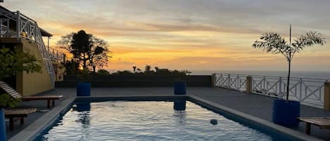 Outdoor pool, open 6:00 AM to 10:00 PM, pool umbrellas, pool loungers
