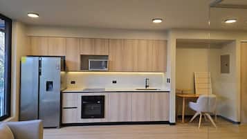 A modern kitchen with a built-in microwave, oven, and refrigerator.