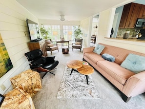 Cozy living room with plush sofa, leather armchair, and ample seating options.