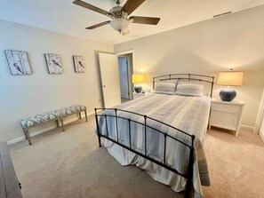 Cozy retreat with a single bed, bench, and two bedside tables, each with a lamp.