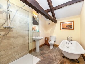 A bathroom with a glass shower enclosure, a pedestal sink, a toilet, and a freestanding bathtub. - Barley Store - UK48910 (Allonby)