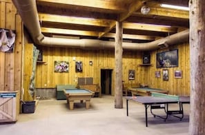 Enjoy games and relaxation in this spacious area with a pool table, ping pong table, and billiards table.