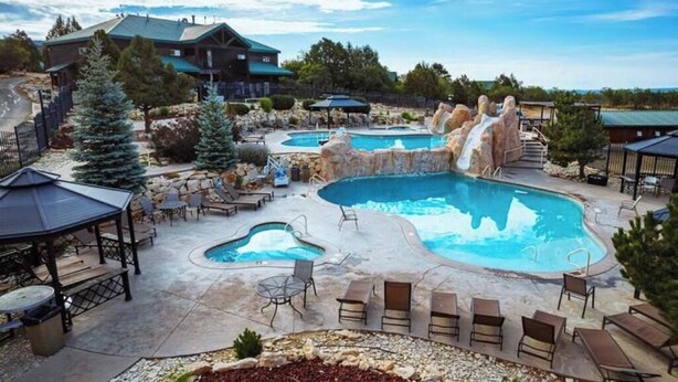 A pool area with multiple pools, lounge chairs, and a gazebo.