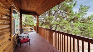 A wooden deck with a railing, a bench, and a table with chairs. - Zion Views- The Ranch House +Resort Access (Orderville)