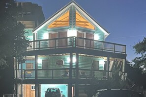 A two-story building with a balcony on the upper level. - 1506 - Cruz n Corolla - Whalehead Retreat w/ Private Pool & Hot Tub (Corolla)