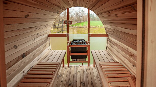 A wooden sauna with benches and a sauna table in the center. - Amazing home in Hadsund with sauna (Hadsund)