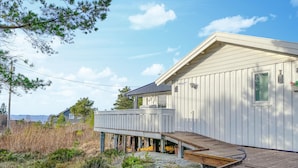 A coastal house with a wooden deck, a covered outdoor area, and a view of the sea. - 2 bedroom amazing home in Agdenes (Agdenes)