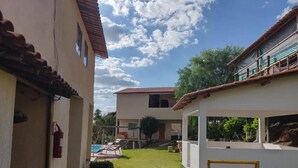 A residential area with a swimming pool, a covered patio, and a small garden.