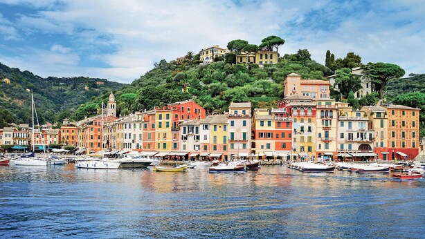 A waterfront with colorful buildings and boats docked.