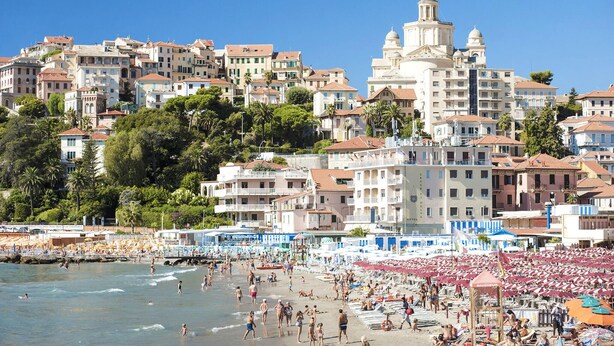 A coastal town with a beach, hotel buildings, and a prominent church. - 2 bedroom nice home in Imperia (Imperia)