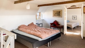A bedroom with a bed, a desk, a chair, and a wardrobe. - Amazing home in ærøskøbing with WiFi (Ærøskøbing)