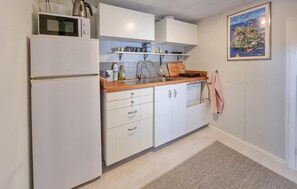 Fridge, microwave, coffee/tea maker, cookware/dishes/utensils