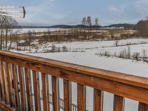 A wooden deck with a view of a snowy landscape. - Kaislaranta by Interhome (Salo)