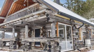 Enjoy a cozy porch with a sheltered outdoor space and a fireplace for warmth.
