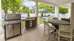 A covered patio with a grill, a table, and chairs. - 7 Bedroom, 4 Full Baths, and Two Blocks to Beach (Cape May)