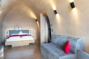 Un dormitorio con cama, sofá y puerta.