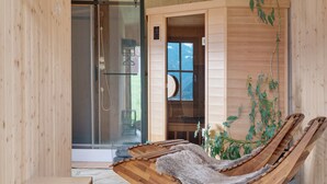 A wooden interior with a glass shower, a sauna, and a wooden chair with a fur throw. - Studio 'Pavilion Water' with Mountain View, Shared Terrace and Wi-Fi (Velturno)