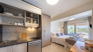 A modern kitchen with a dishwasher, a wooden countertop, and a built-in oven. - Studio Apartment 'Katerina' with Mountain View, Wi-Fi and Air Conditioning (Gaios)