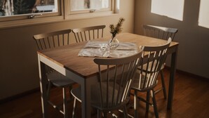 A dining area with a wooden table and four chairs. - Vargen 2 by Interhome (Tännäskröket)