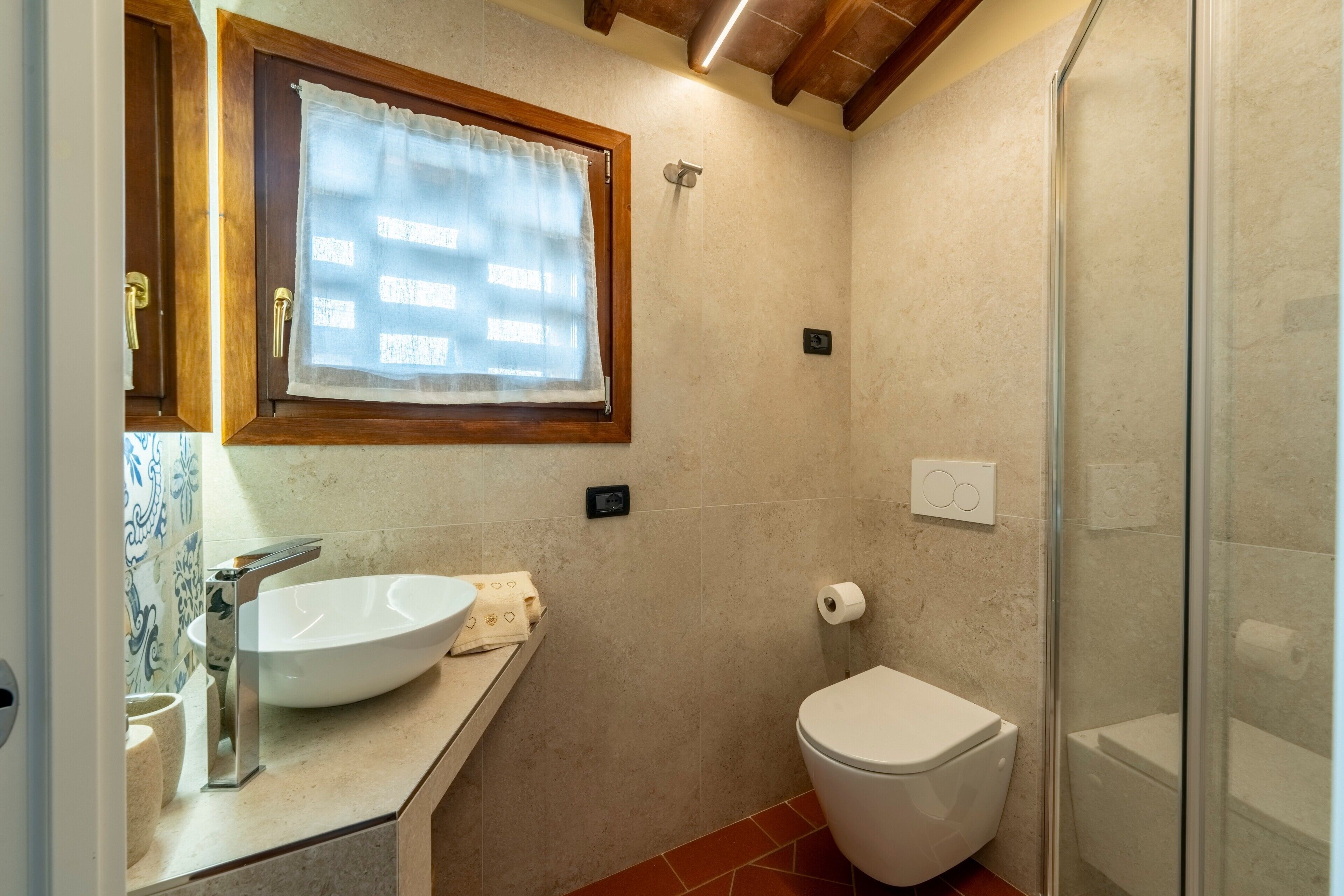 A bathroom with a sink, toilet, and shower.