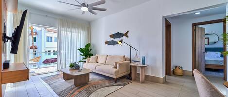 A modern living room with a sofa, coffee table, and a ceiling fan.
