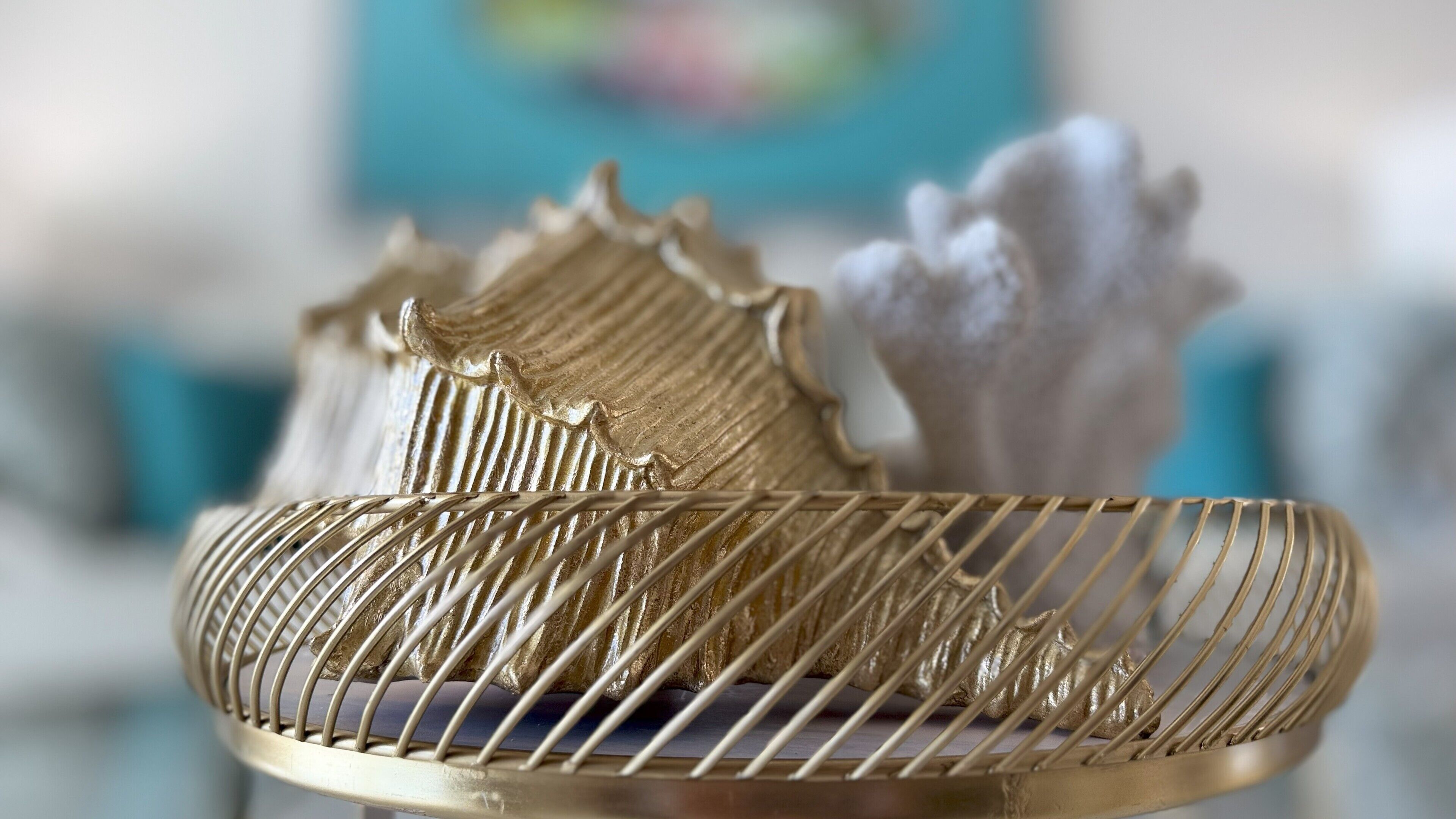 A close-up of a golden decorative object with intricate patterns, possibly a piece of furniture or a decorative item.