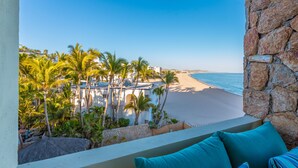 A balcony with a view of a beach and palm trees. - Beachfront, Ocean View, Amazing Location! (San José del Cabo)