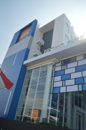 A modern building with a prominent 'BROMO PARK' sign, large glass windows, and a distinctive blue and white facade. - Bromo Park Hotel (Probolinggo)