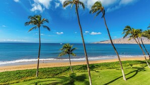 A beach with palm trees and a clear blue sky. - Sugar Beach #131: Front-row views, salty air & instant beach access—pure Maui! (Kihei, Maui)