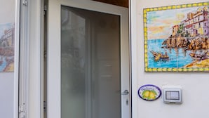 A door leading to a room with a wall-mounted welcome sign and a power outlet.