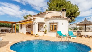 A villa with a swimming pool, outdoor seating, and a covered patio area. - Carlota by Interhome (Moraira)