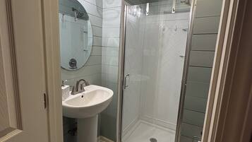 Shower, hair dryer, towels, toilet paper