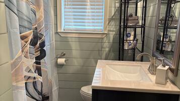 Shower, hair dryer, towels, toilet paper