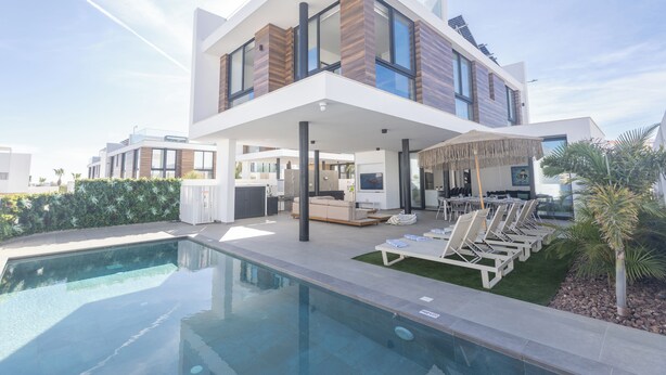 A modern two-story house with a swimming pool, outdoor seating area, and a covered patio. - Protaras Aqua Pearl Villa Aq18 (Paralimni)