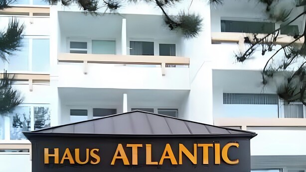 The entrance to a hotel named 'HAUS ATLANTIC' with a modern architectural design, featuring a prominent sign and a covered entrance area. - Apartment 'Dargies' with Sea View, Balcony and Wi-Fi (Cuxhaven)