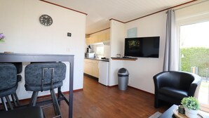 A compact living space with a kitchen, dining area, and a seating area.
