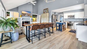 A modern kitchen with white cabinets, a built-in oven, and a microwave.