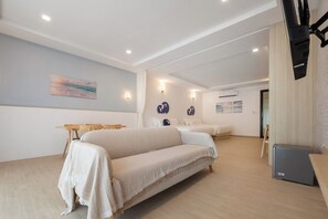 A hotel room with a large bed, a desk, and a television. - Kokotel Krabi Seaside (Krabi)