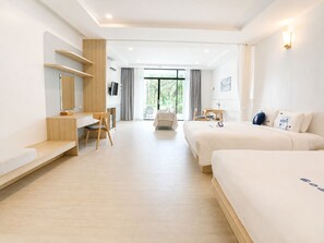 A hotel room with a bed, a desk, a chair, a small table, and a TV. - Kokotel Krabi Seaside (Krabi)
