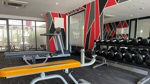 A gym with exercise equipment, including a bench and weight racks. - Beaufort Ridge (Accra)