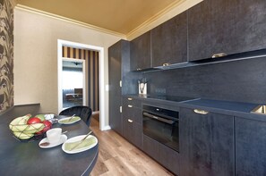Enjoy cooking in this well-equipped kitchen with an oven, stainless steel sink, and dining table.