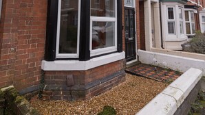 A row of terraced houses with brick facades and white window frames.