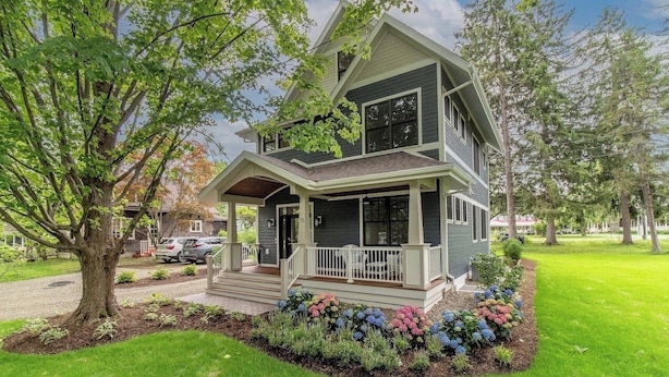 A two-story house with a front porch, a driveway, and a well-maintained lawn. - 73 Cook Lower - Brand New Apartment in Chautauqua! (Chautauqua)
