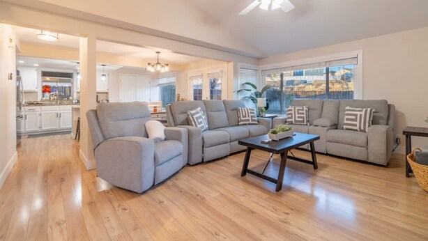 A spacious living room with a sectional sofa, a coffee table, and a ceiling fan. - Modern 3-bedroom Escape in Northwest Reno (Reno)