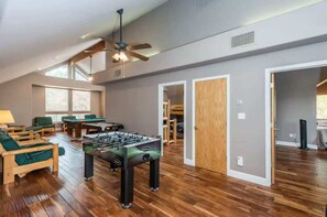 A spacious room with a foosball table, a pool table, and a ceiling fan. - Handels Pride- Family friendly, Game Room & Views (Shaver Lake)